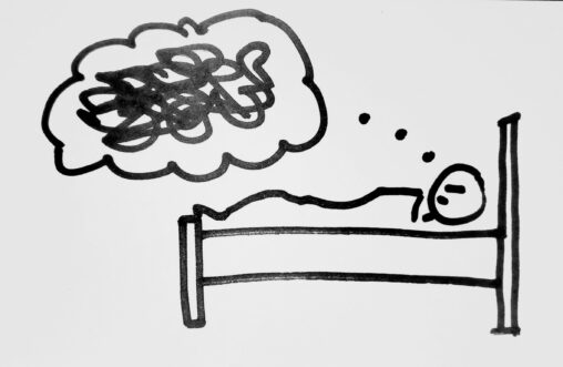 person laying in bed with a thinking bubble full of scribbles