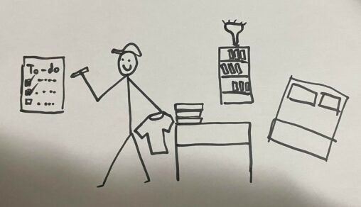 The stick figure is ticking off things from his to-do list while he folds laundry