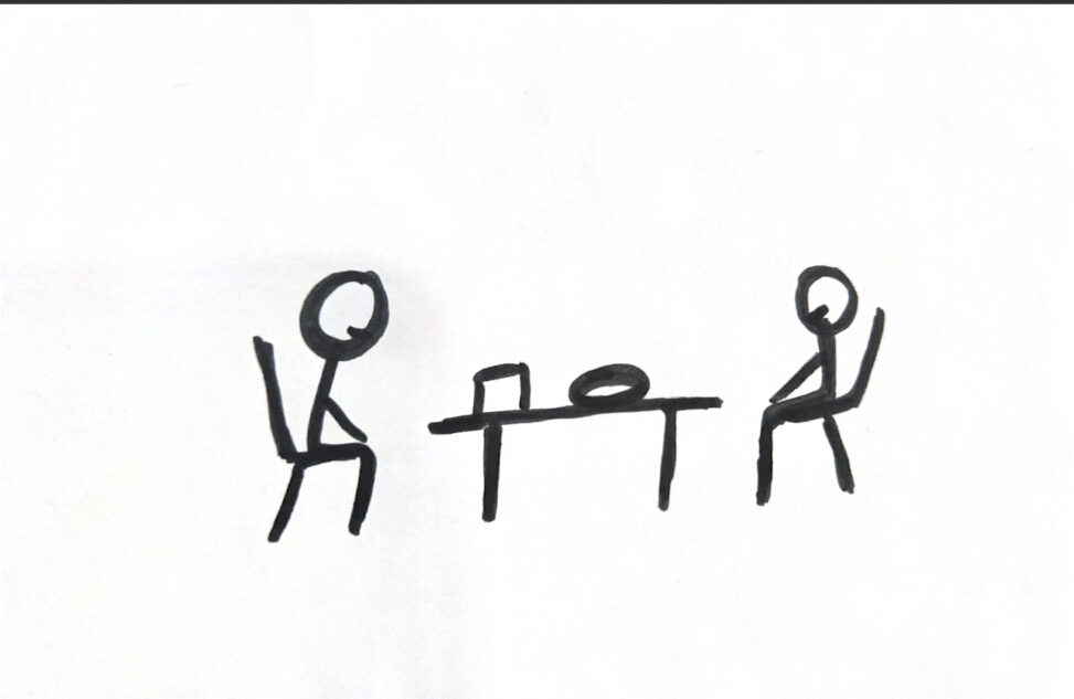 The stick figure person is sitting on a table with her friend with a pizza on the table.